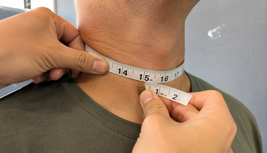 Close-up of hands measuring neck circumference with tape
