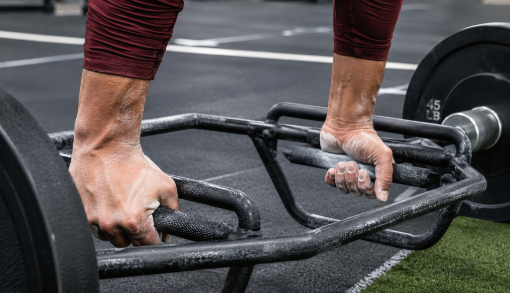 Close-up of hands gripping a trap bar during a lift