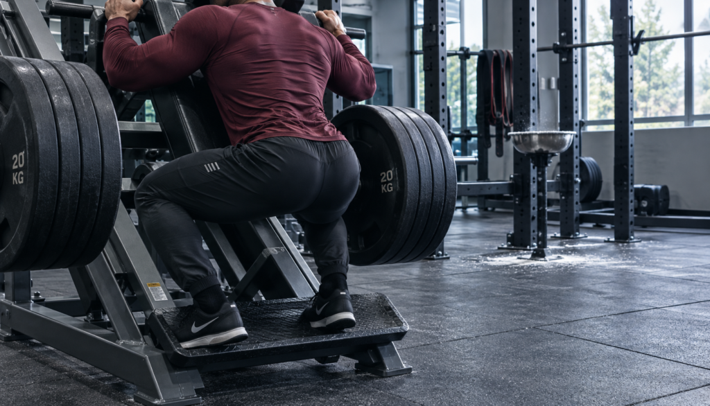Lifter mid-set on plate-loaded machine, three-quarter angle, faceless