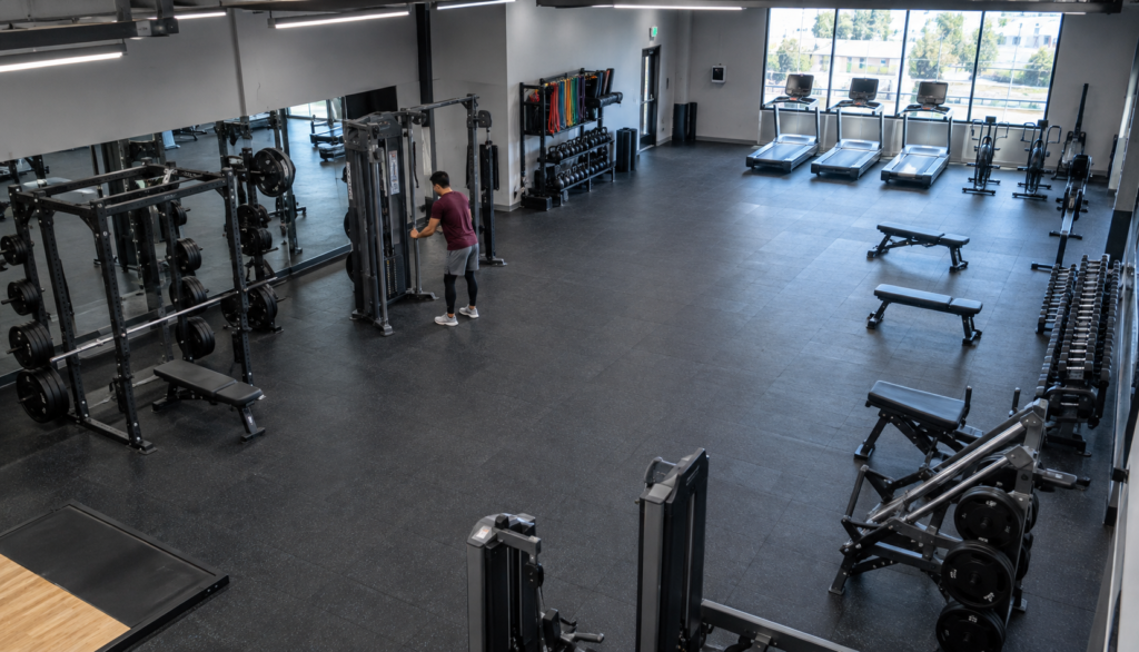Wide gym shot of chest press machine training during a cutting phase